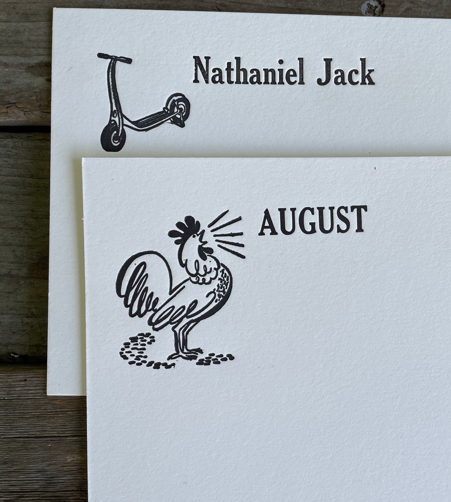 Two white letterpress cards with black illustrations and text