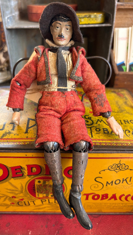 Vintage-style toy figure on a tobacco box