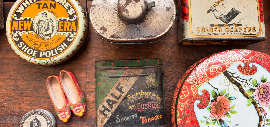 Collection of vintage tins including Whittemore's Shoe Polish and Surbrug's Golden Seepyre on a wooden surface.