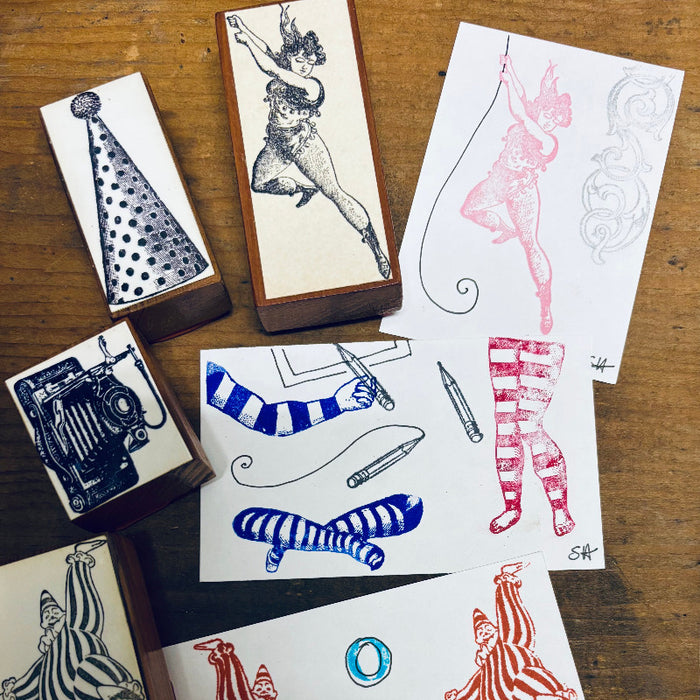 Collection of rubber stamps with various illustrations on a wooden surface